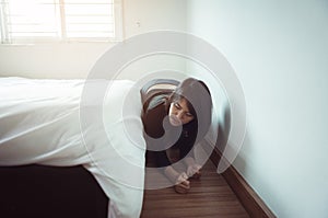 Woman bent and searching something under bed