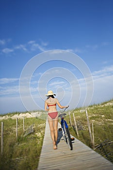 Woman with Bicycle on Boardwalk