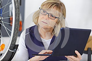 Woman bicycle enginee looking at bike model in pc