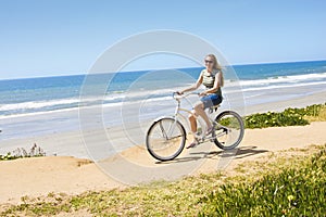 Woman on a Bicycle Ride along the beach