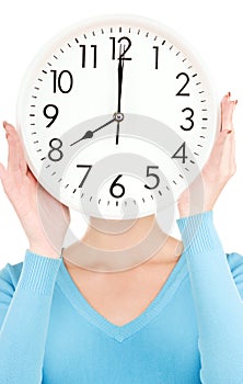 Woman with big clock covering face