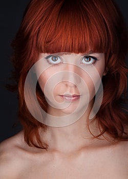 Woman with big eyes and red hair