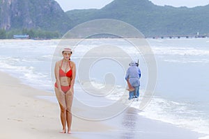 Woman big shape enjoy with red bikini and hat on beach