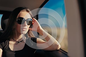Woman with Big Sunglasses Traveling by Car