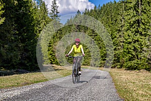 Woman on bike in forest