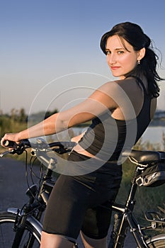 Woman on bike is having rest