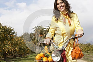 Woman on Bike with Oranges