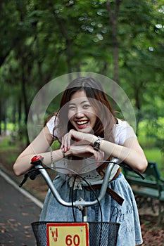 Woman with a bike outdoors smiling