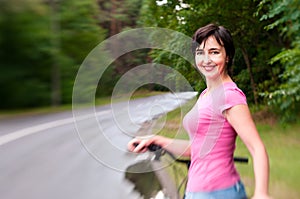 Woman with bike on the rainy forest