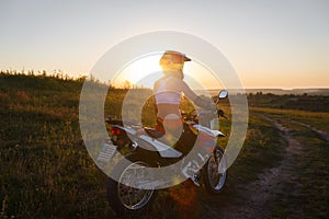 Woman biker in sunset, female motorcycle.