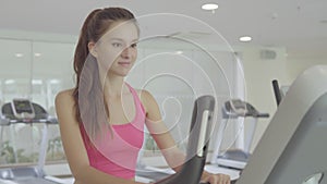 Woman biking in the gym, close up