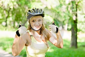 Woman with biking helmet showing thumbs up