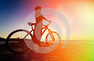 Woman biking at sunset