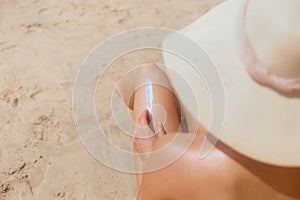 Woman in Bikini Applying Sun Cream on Leg. Sun Protection. Skin and Body Care. Girl Using Sunscreen to Skin.