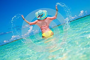 Woman in bikini having fun on the beach in Exuma, Bahamas