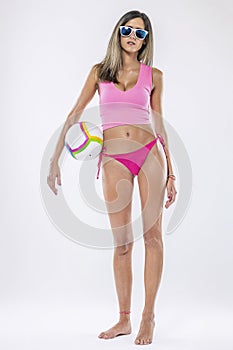 Woman in bikini holding beach ball