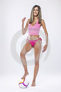 Woman in bikini holding beach ball photo