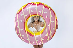 Woman in bikini with large inflatable swimming ring