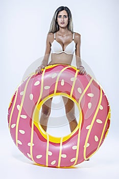 Woman in bikini with large inflatable swimming ring