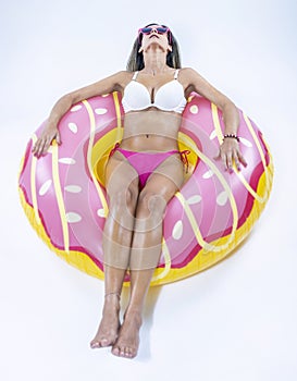 Woman in bikini with large inflatable swimming ring