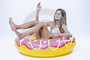 Woman in bikini with large inflatable swimming ring photo