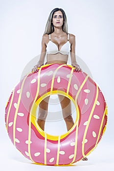 Woman in bikini with large inflatable swimming ring photo