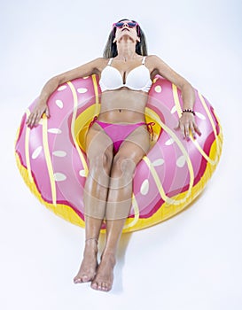 Woman in bikini with large inflatable swimming ring photo