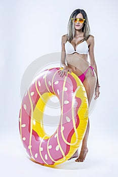 Woman in bikini with large inflatable swimming ring photo