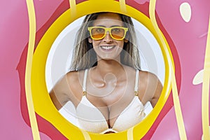 Woman in bikini with large inflatable swimming ring photo