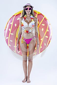 Woman in bikini with large inflatable swimming ring photo