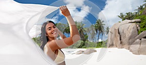 woman in bikini with pareo on seychelles beach
