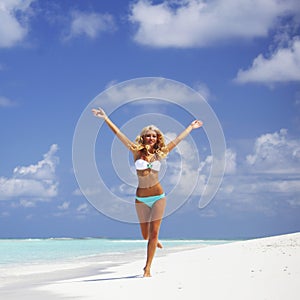 Woman in bikini running on the beach