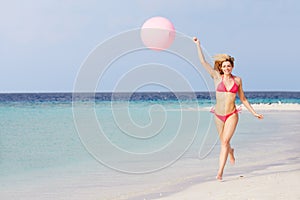 Woman In Bikini Running On Beautiful Beach With Balloon