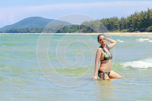 Woman and bikini show with sunshine on beach