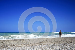 Woman in bikini standing on the beach