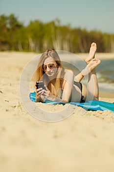 Woman in bikini sunbathing and relaxing on beach