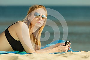 Woman in bikini sunbathing and relaxing on beach