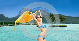 Woman in bikini and sunglasses on bora bora beach