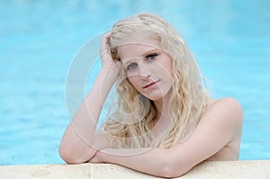 Woman with bikini in swimming pool on vacation