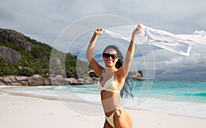 woman in bikini swimsuit with cover-up on beach