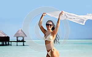 woman in bikini swimsuit with cover-up on beach