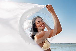 woman in bikini swimsuit with cover-up on beach