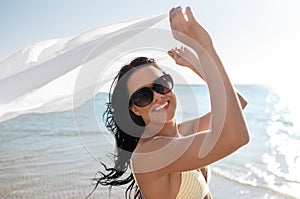 woman in bikini swimsuit with cover-up on beach