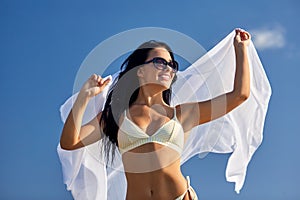 woman in bikini swimsuit with cover-up over sky