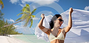 woman in bikini swimsuit with pareo on beach