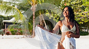 woman in bikini swimsuit with pareo on beach