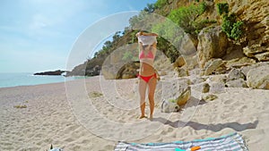 Woman in a bikini walking in clear blue water on a tropical island during summer vacation. Underwater view of friends