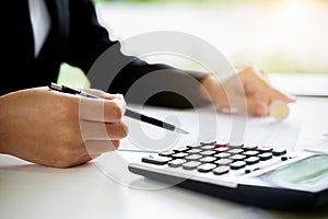 Woman with bills and calculator. Woman using calculator to calculate bills at the table in office. Calculation of costs.