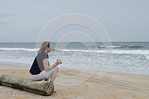 Woman with binoculars on beach 2