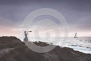 Woman with binoculars observes the infinite ocean , concept of freedom and travel